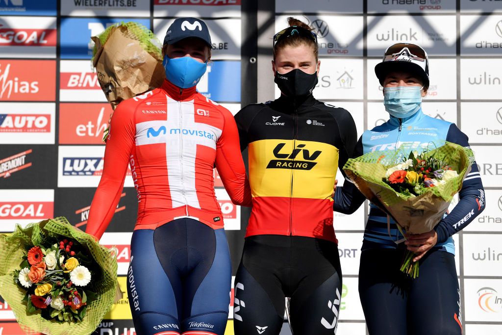 DOUR BELGIUM MARCH 02 Podium Emma Norsgaard Jorgensen of Denmark and Movistar Team Lotte Kopecky of Belgium and Team Liv Racing Celebration Chloe Hosking of Australia and Trek Segafredo during the 10th Le Samyn des Dames 2021 Womens Elite a 925km race from Quaregnon to Dour Mask Covid safety measures Flowers GPSamyn on March 02 2021 in Dour Belgium Photo by Mark Van HeckeGetty Images