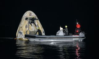 Support teams work around the SpaceX Crew Dragon "Resilience" spacecraft shortly after it landed in the Gulf of Mexico, on May 2, 2021.