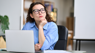 Woman thinking at desk