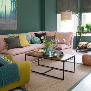 living room with mustard yellow armchair and pink sofa