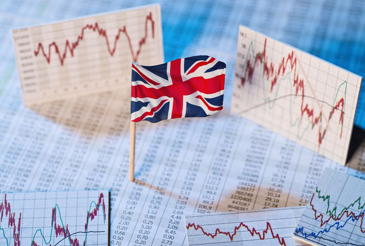 Economic development and UK stock market concept with UK&#039;s Union Flag and graphs