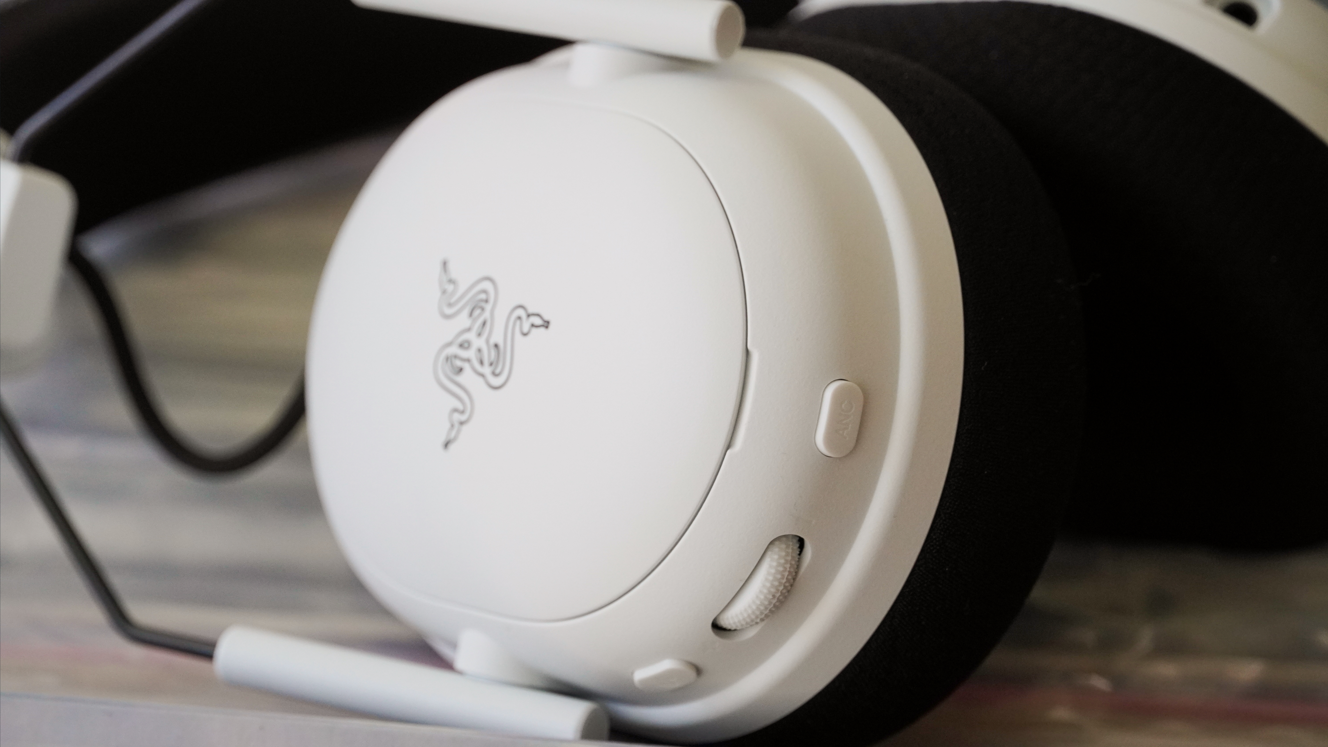 The Razer BlackShark V3 Pro gaming headset laid atop records showing the customizable ear caps.
