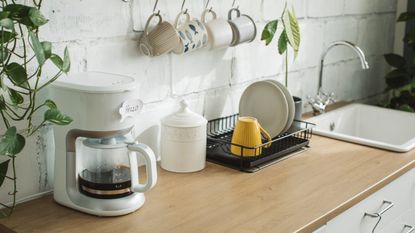 A coffee maker on a wood kitchen countertop