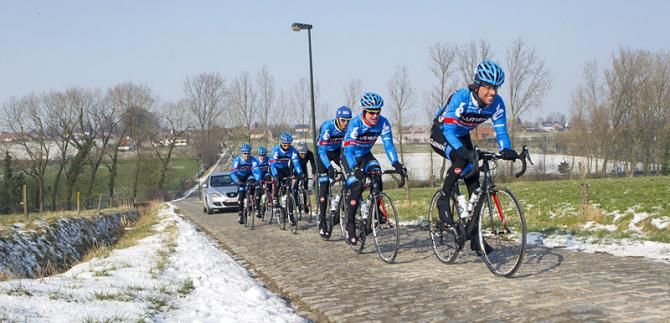 Thomas Dekker leads his Garmin-Sharp teammates over a sector of pave along the Omloop Het Nieuwsblad route.