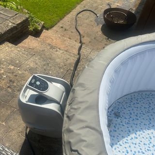 The Lay-Z-Spa Barabados inflatable hot tub on a paved patio