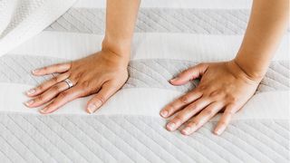 Hands resting on Leesa Original Mattress