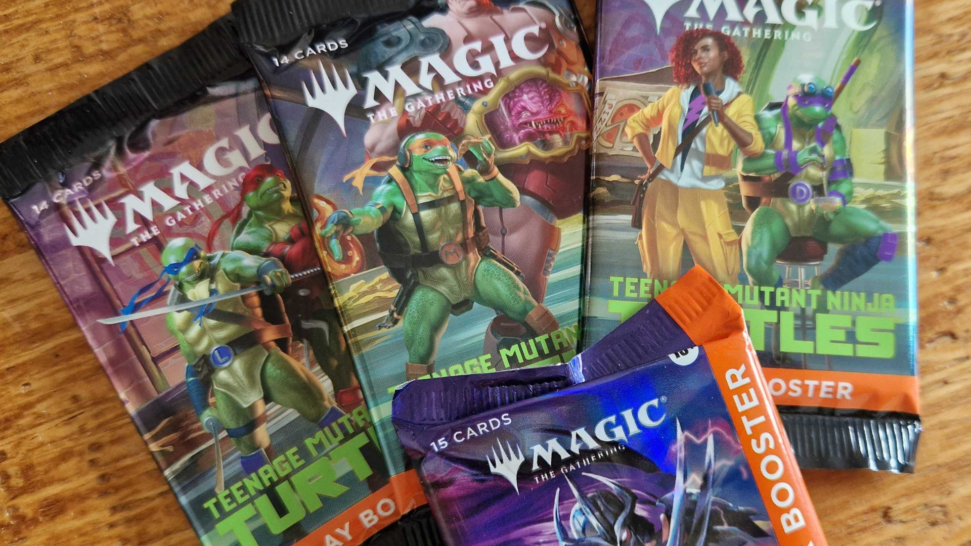 MTG Teenage Mutant Ninja Turtles Play and Collector Boosters laid out on a wooden surface