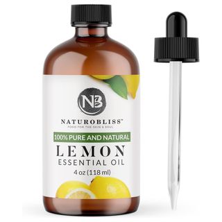 A brown glass bottle of lemon essential oil with a pipette