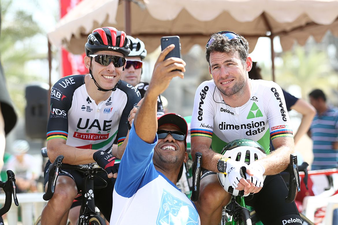 Former world champions Rui Costa and Mark Cavendish pose with a fan at the Tour of Oman.
