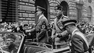 Adolf Hitler (left) and Benito Mussolini (right) travel through Rome in an open top car in May 1938