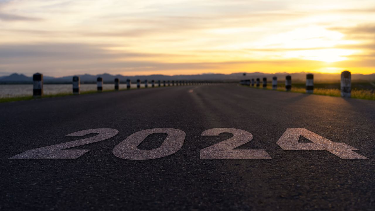 2024 is superimposed on top of a road that leads into the distance. 