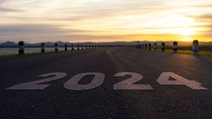 2024 is superimposed on top of a road that leads into the distance. 