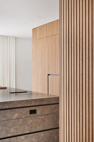 kitchen with wood cupboards and dark marble island