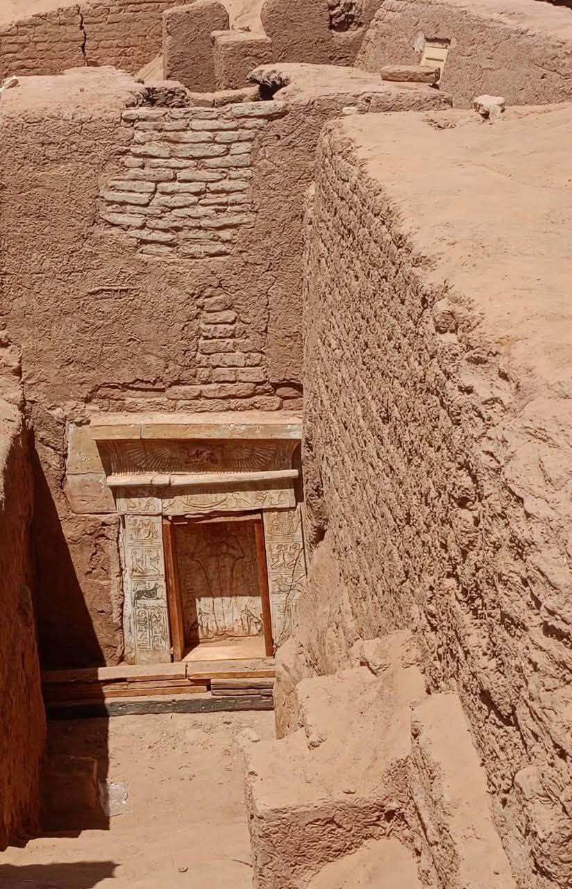 An image shows stone steps leading to a vertical doorway.
