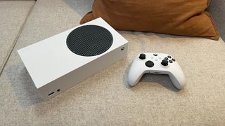 Xbox Series S console and controller on a sofa