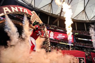 The Falcons sports team with smoke in the air