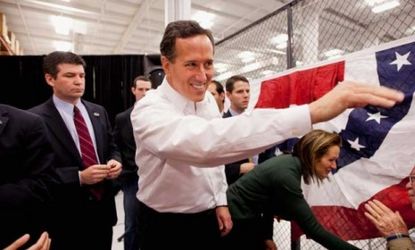 Rick Santorum greets supporters at a rally in Missouri on Saturday: The GOP presidential hopeful cleaned up in Kansas' caucuses, scoring 51 percent of the vote.