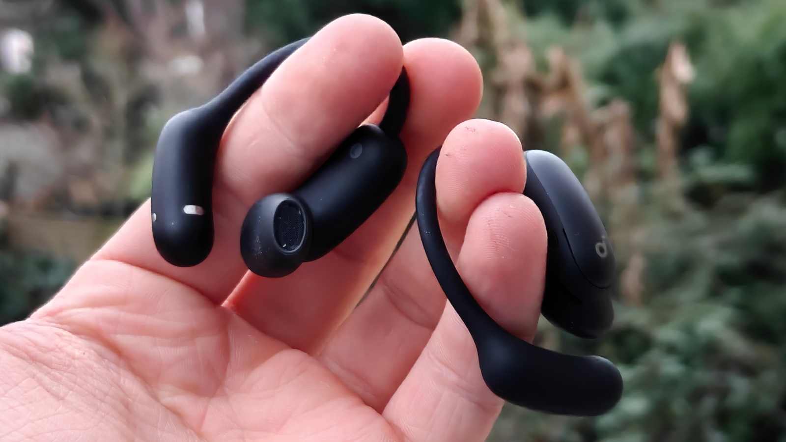 The Soundcore Aerofit 2 Pro in a man's hand.