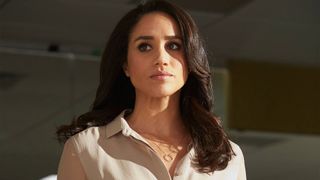 Rachel Zane looks concerned as she looks at someone off-screen in Suits
