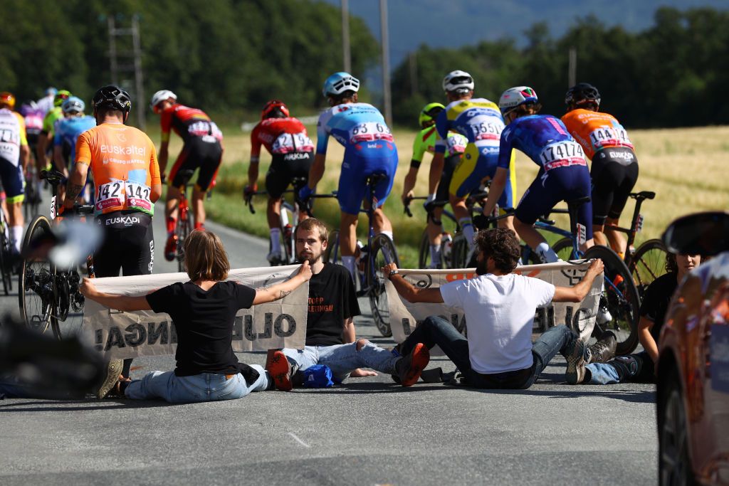 TRONDHEIM NORWAY AUGUST 14 Protesters block the race during the 9th Arctic Race Of Norway 2022 Stage 4 a 1591km stage from Trondheim to Trondheim ArcticRace on August 14 2022 in Trondheim Norway Photo by Michael SteeleGetty Images
