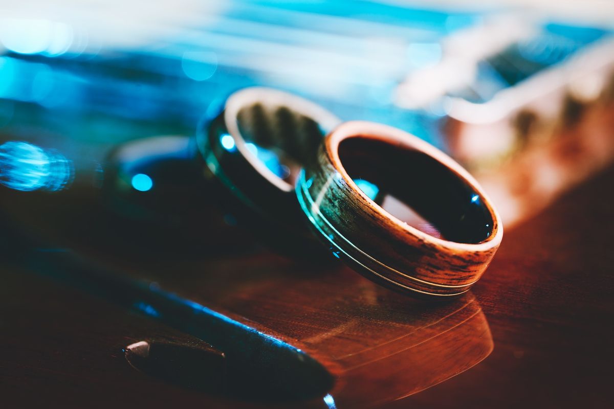 Some of Fender's new wedding rings, set against various Fender-themed backdrops