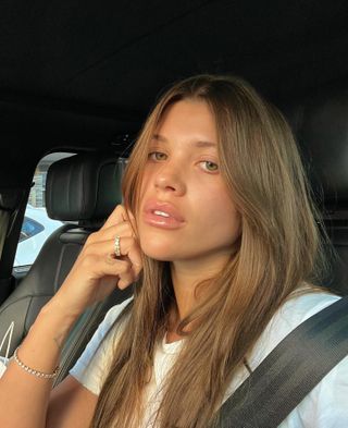 Sofia Richie Grainge taking selfie wearing tennis bracelet.