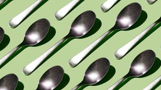 Spoons laid out against a green background