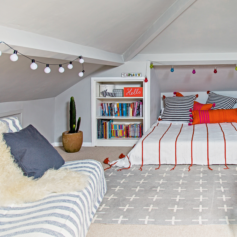 white loft bedroom with fairy lights and daybed