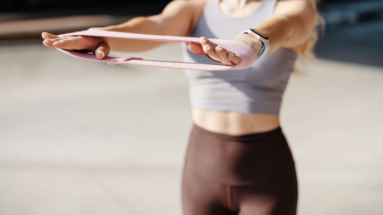 A woman doing a resistance band workout