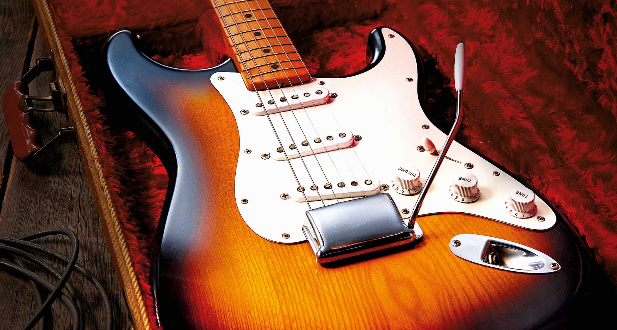 A pristine vintage Fender Stratocaster pictured in its case.