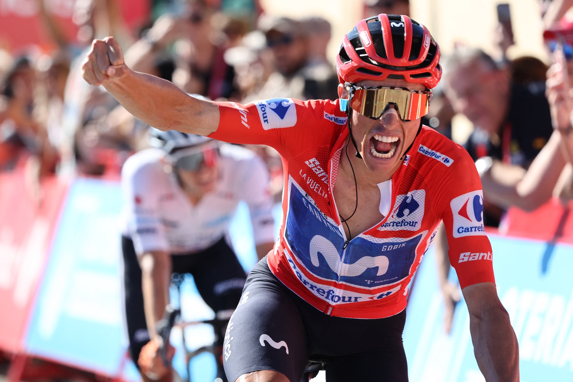 Team Movistar's Spanish rider Enric Mas celebrates his victory followed by Team Netcompany Ineos' Scottish rider Oscar Onley during the 9th stage of the Vuelta a Espana 2026 cycling tour, a 187,4 km race between Villajoyosa and Alto de Aitana in Confrides, on August 30, 2026. (Photo by Josep LAGO / AFP)