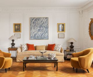 living room gold tub chairs beige sofa ornate plasterwork