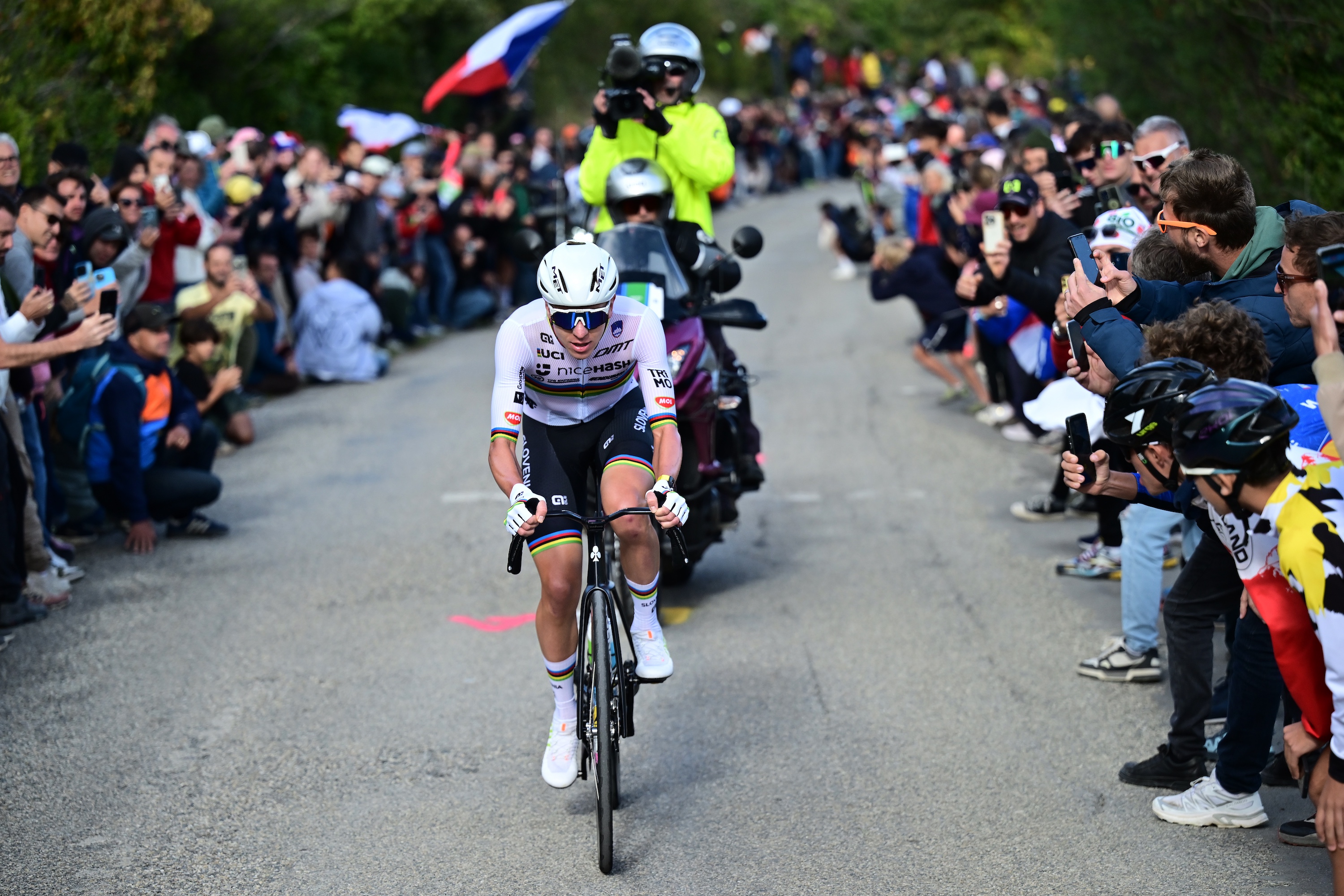 Tadej Pogacar rides to victory at the European Championship 2025 flanked by roadside fans