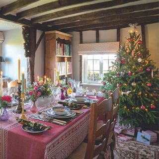 Decorated Christmas tree in dining room with tablescaping