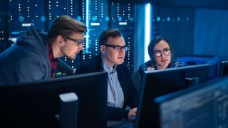 CISO in a cyber security operations center with two colleagues