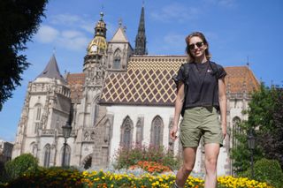 Image shows Anna wearing the Fjällräven/Specialized Rider’s Hybrid shorts as she walks away from St Michael's Chapel in Košice.