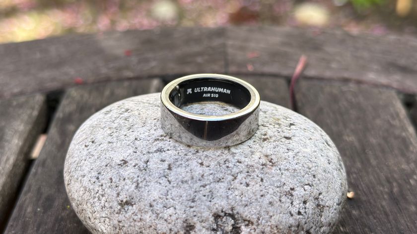 The Ultrahuman Ring Air sitting atop a rock, showing &quot;Ultrahuman Ring Air&quot; engraved inside.