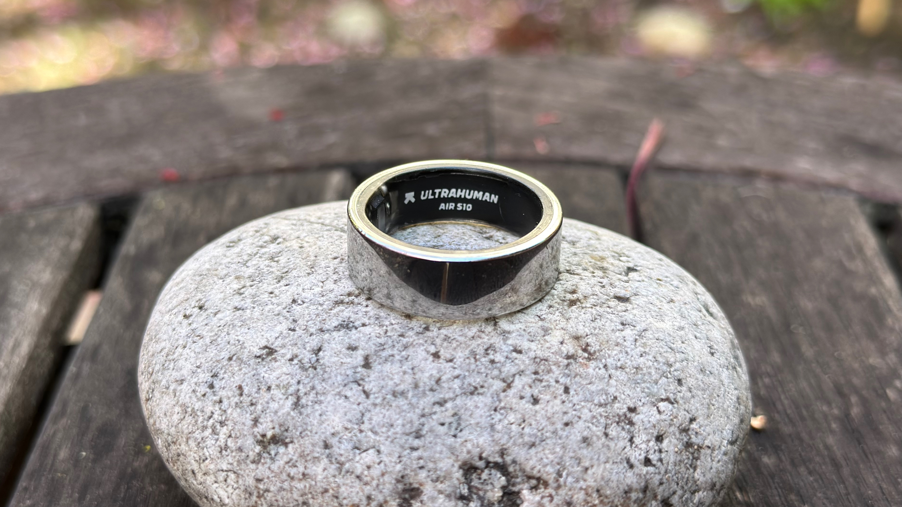 The Ultrahuman Ring Air sitting atop a rock, showing 