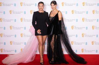 Florence Pugh and Millie Bobby Brown pose in the winners room during the EE British Academy Film Awards 2022 at Royal Albert Hall on March 13, 2022 in London, England
