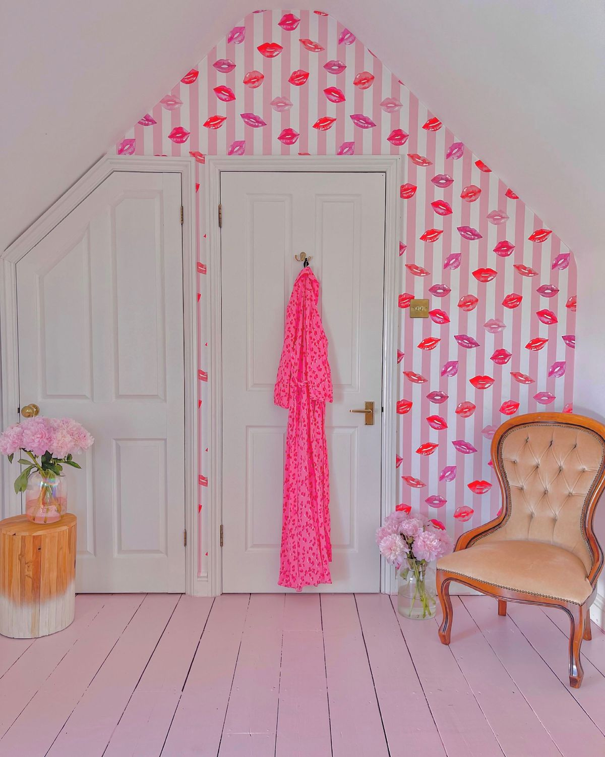 Pink office with chair and lipstick wallpaper with a built in cupboard