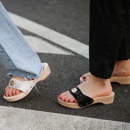 street style shot of women wearing black and white dr scholls clogs sandals