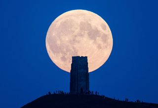 The supermoon rises behind Glastonbury Tor on Sept. 27, 2015 in Glastonbury, England.