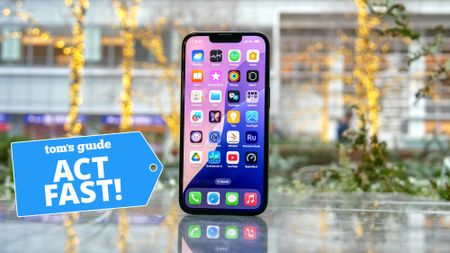 iPhone 16e on surface with Act Fast badge nearby.