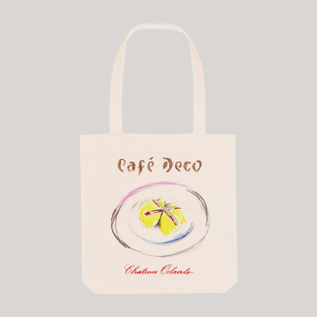 Chateau Orlando x Café Deco Egg Mayonnaise Tote Bag in beige placed against a pale grey background.