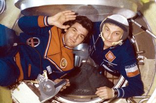 Mirosław Hermaszewski (at right), the first Pole in space, enters the Salyut 6 space station with cosmonaut Pyotr Klimuk.
