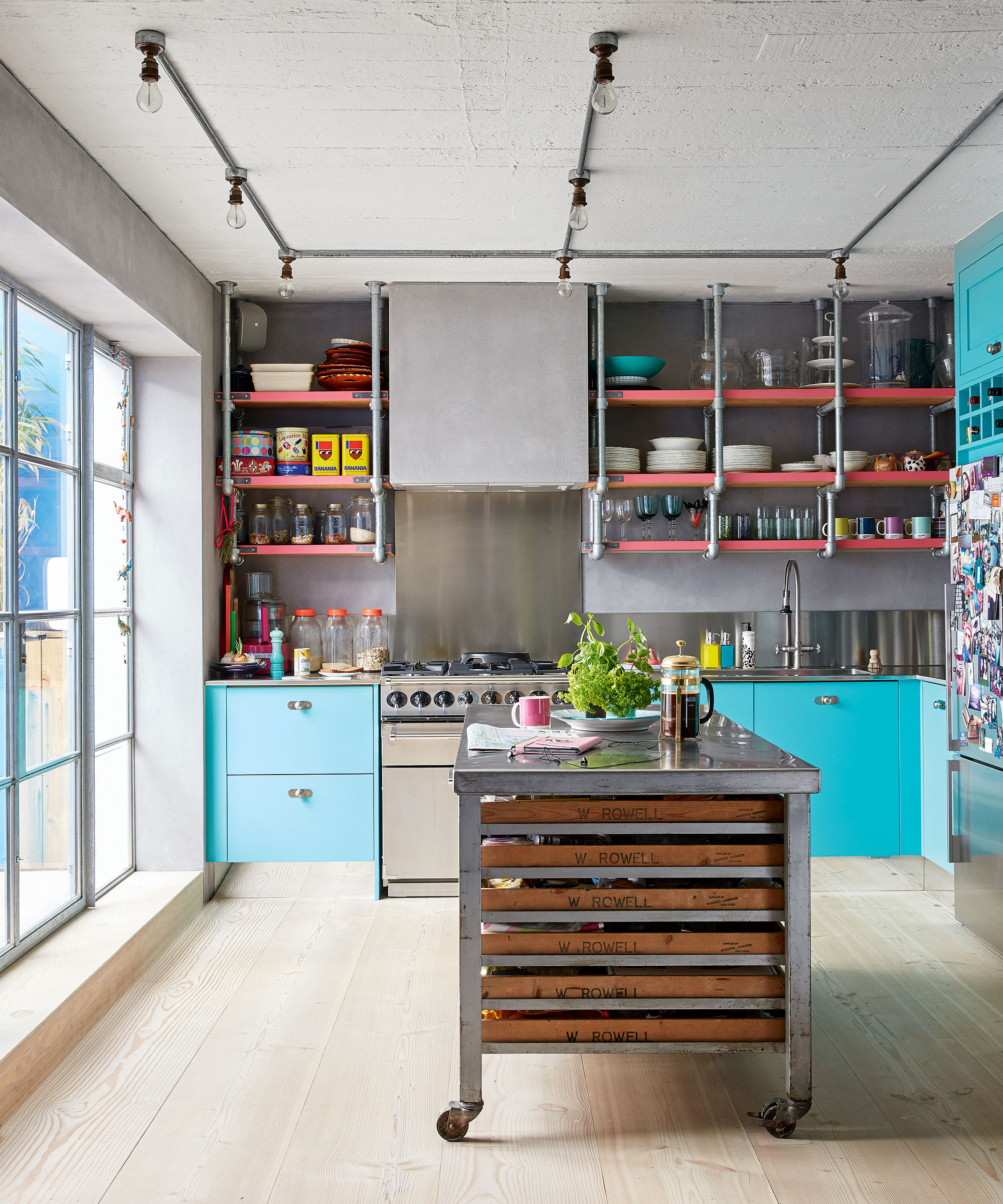 Turquoise and stainless steel kitchen with orange details