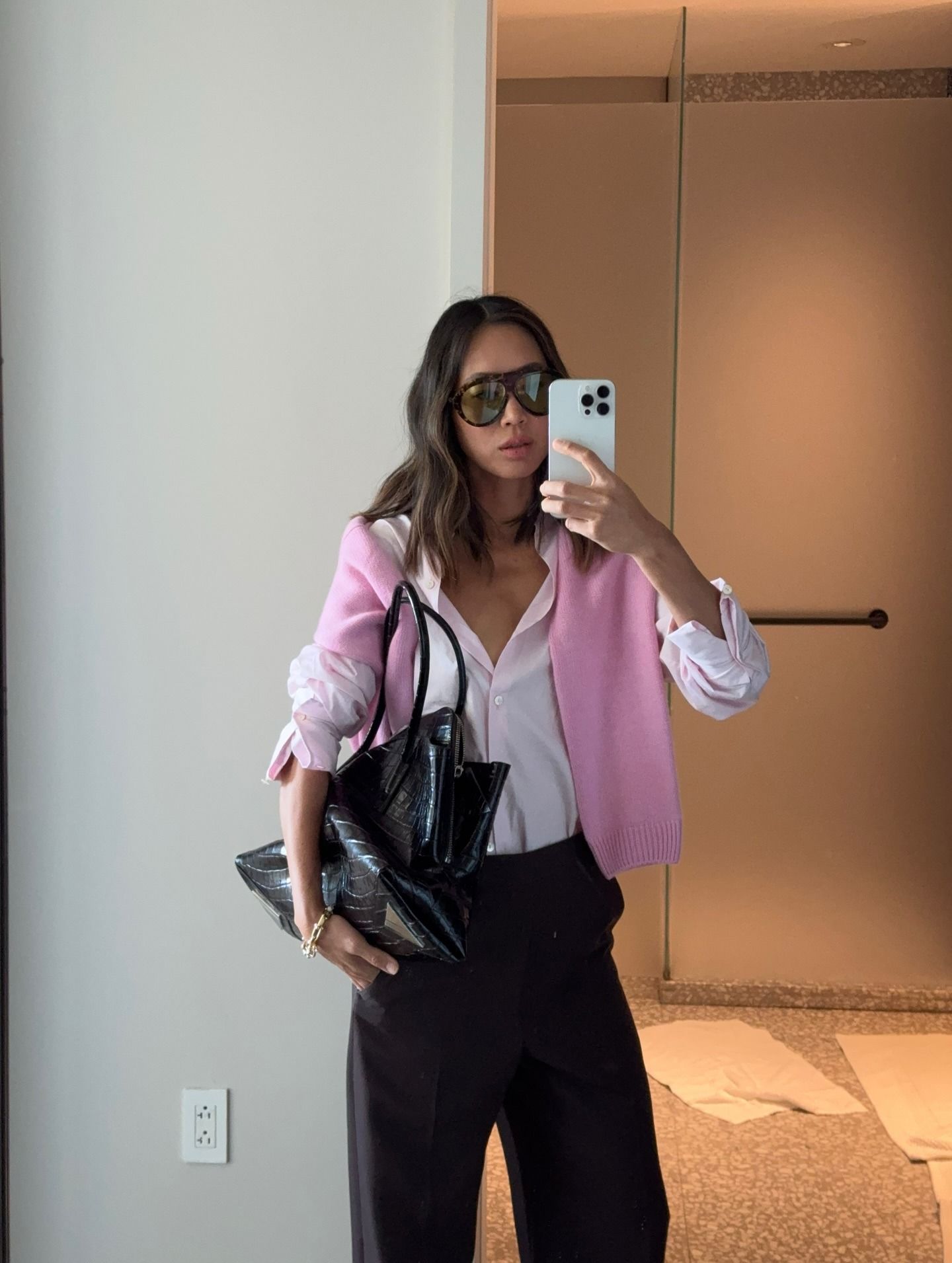 Aimee Song wearing a sweater draped over her shoulders and a collared shirt