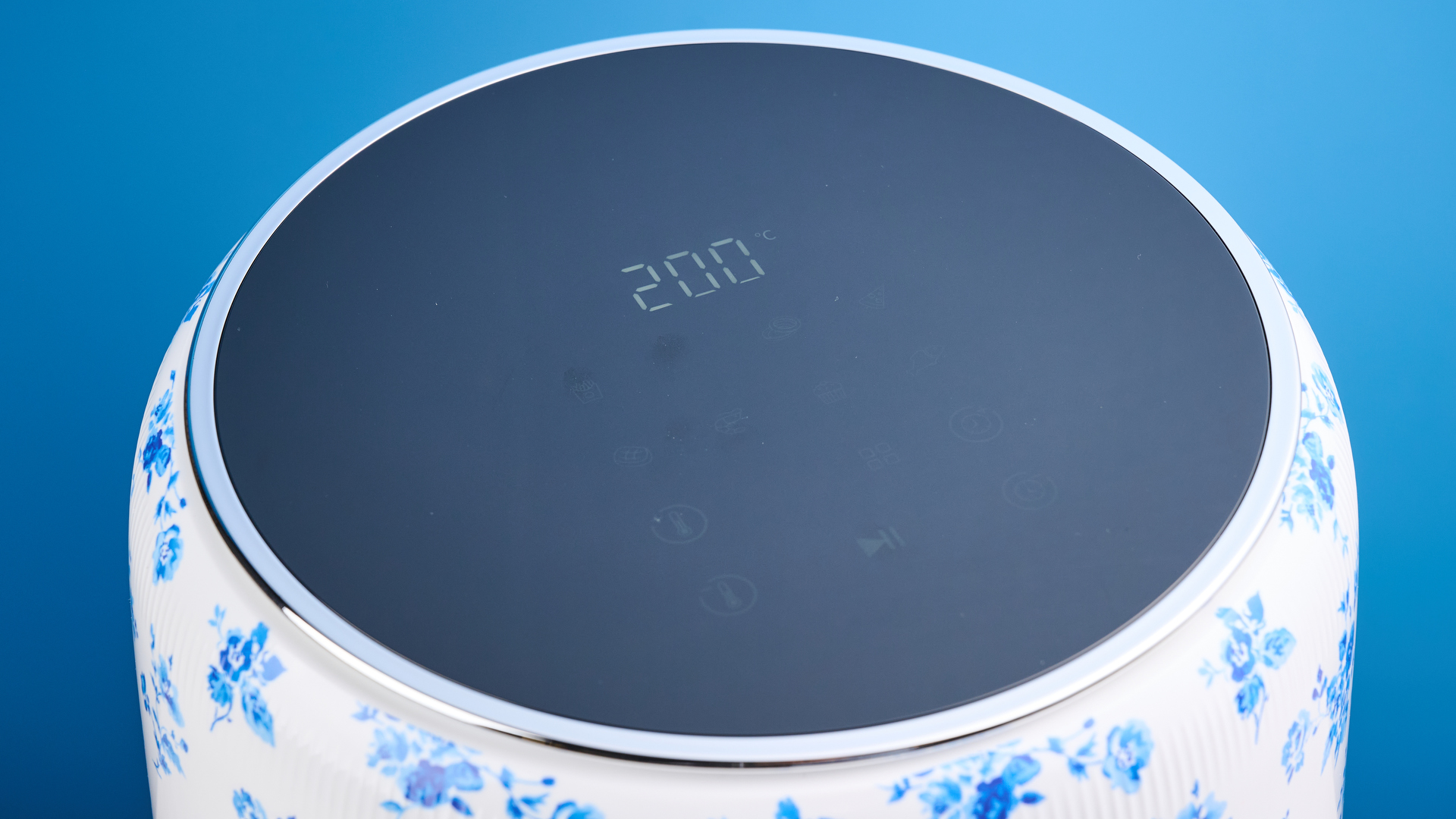 the Laura Ashley Air Fryer in blue and white floral print, showing the air fryer basket and black touchscreen on the top
