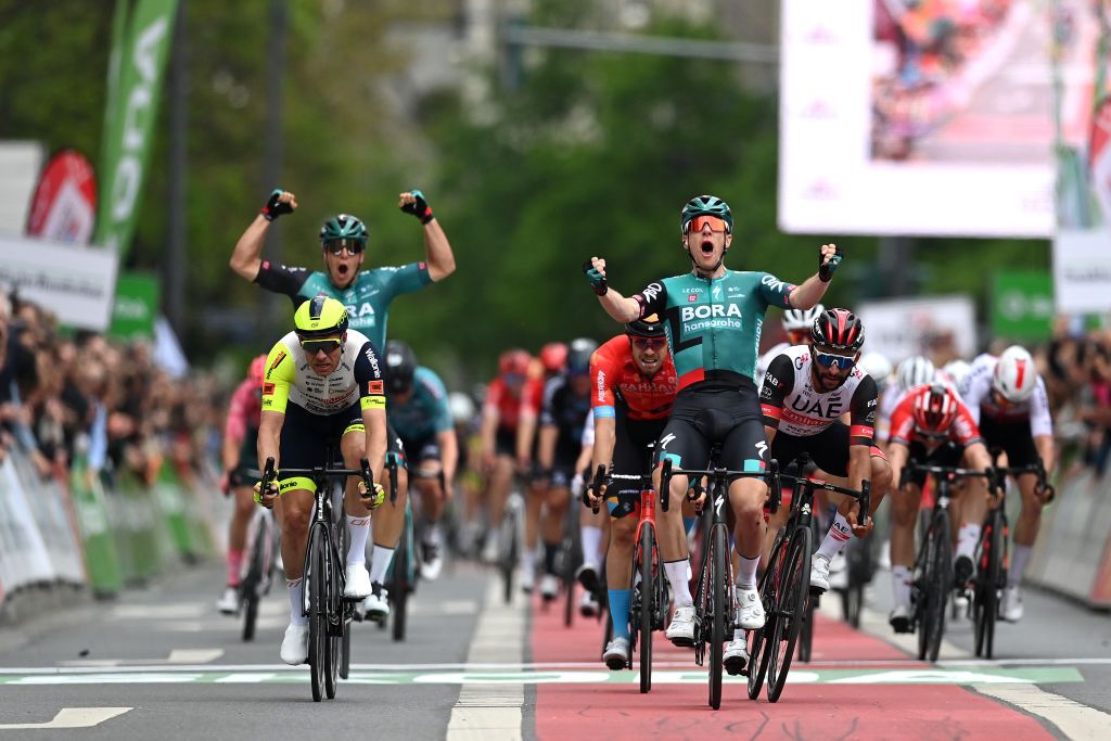 FRANKFURT AM MAIN GERMANY MAY 01 Sam Bennett of Ireland and Team Bora Hansgrohe celebrates at finish line as race winner ahead of Alexander Kristoff of Norway and Team Intermarch Wanty Gobert Matriaux L and Fernando Gaviria Rendon of Colombia and UAE Team Emirates R during the 59th EschbornFrankfurt 2022 a 185km one day race from Eschborn to FrankfurtamMain WorldTour on May 01 2022 in Frankfurt am Main Germany Photo by Stuart FranklinGetty Images
