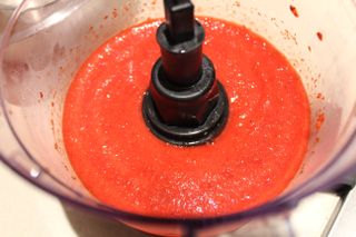 A finished pink raspberry puree made in the Oster 10-Cup Food Processor with Easy-Touch